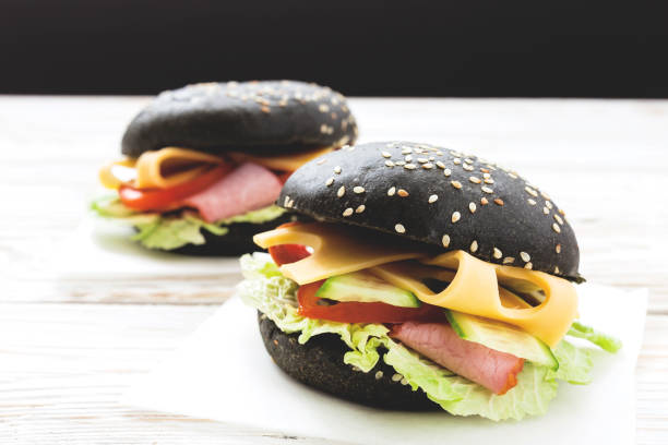 istock Black Hamburger with ham, cheese, cucumber, tomato and lettuce 638513156