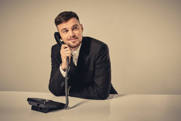 istock young man dials the phone number while sitting in the 638514072
