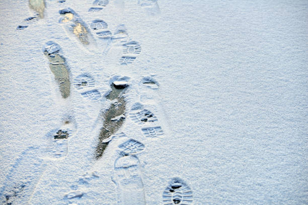 istock Shoe prints on ice - danger walking on ice 638514704