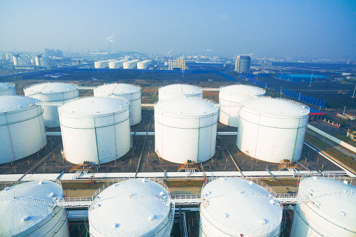 top view of white oil tank in modern refinery plant in blue sky
