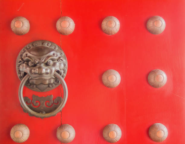 istock Chinese lion head door knocker on red door 638516202
