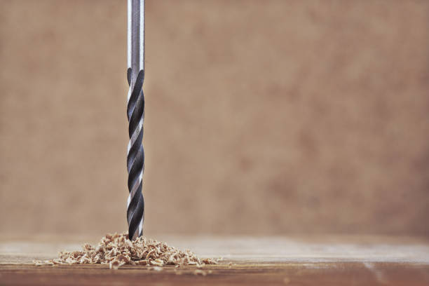 istock new metal drill bit and wooden pine plank 638517222