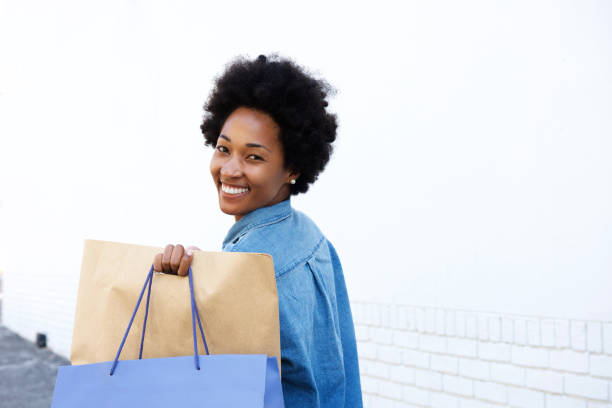 istock Happy woman walking with shopping on sidewalk 638519256