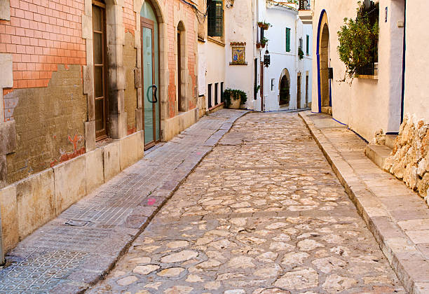 Sitges street with typical roman pavement in the grond, really slippery pavement, take care if you visit this village a rainy day. 