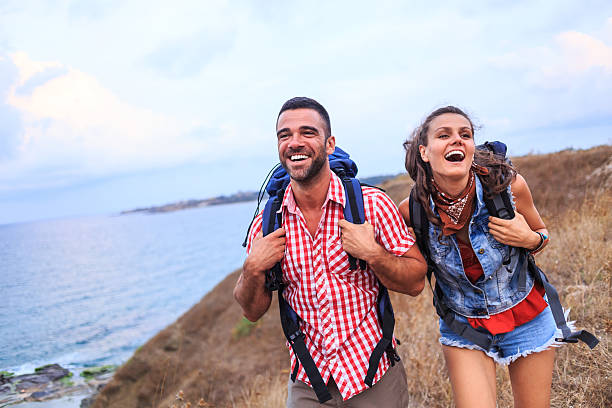 istock Couple backpackers hiking in nature and having fun 638521226
