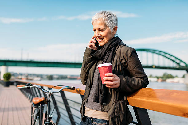 istock Mature Woman Talking On The Phone And Drinking Coffee. 638525958