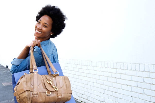 istock Smiling young woman walking with bags 638526216