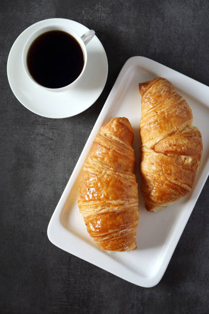 istock Two fresh croissants and cup of coffee 638526566
