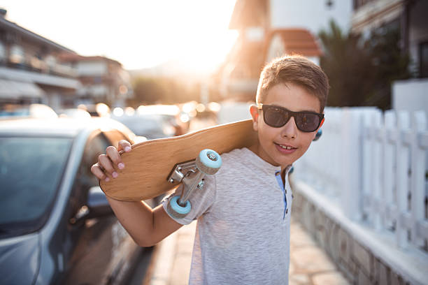 istock Boy with skateboard on the street 638526862