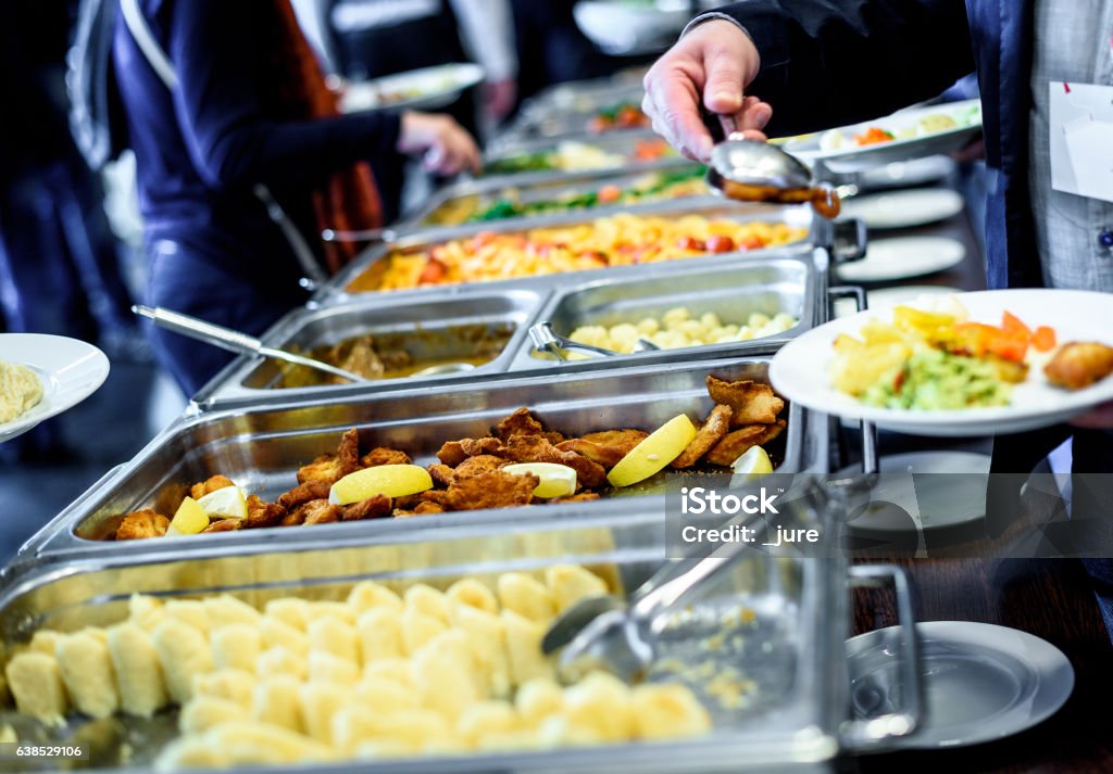 Cuisine Culinary Buffet Dinner Catering Dining Food Celebration Cuisine Culinary Buffet Dinner Catering Dining Food Celebration Party Concept. Group of people in all you can eat catering buffet food indoor in luxury restaurant with meat and vegetables. Cafeteria Stock Photo