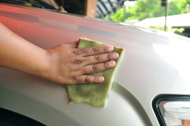 istock Worker use old sponge polishing do shiny on car bonnet 638533430