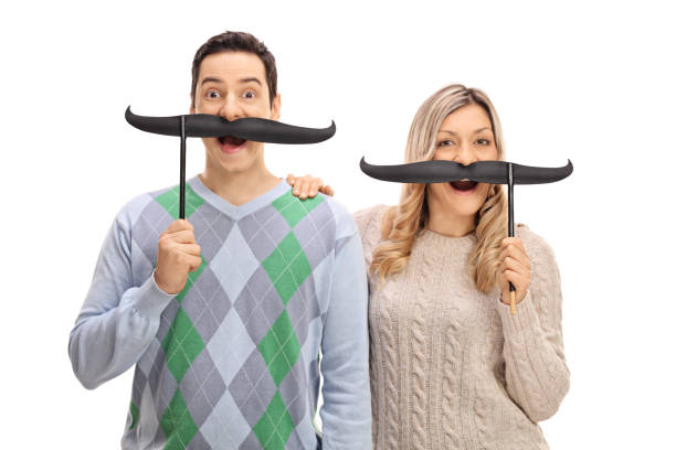 Joyful young man and woman posing with fake moustache Joyful young man and a woman posing with fake moustache isolated on white background women movember mustache facial hair stock pictures, royalty-free photos & images