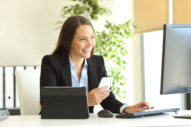 istock Happy businesswoman working with multiple devices 638534968