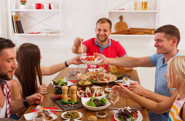 istock People say cheers clink glasses at festive table dinner party 638535082