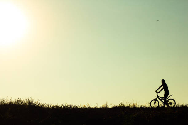 istock Silhouette of children cyclist riding Movement on the background 638536344