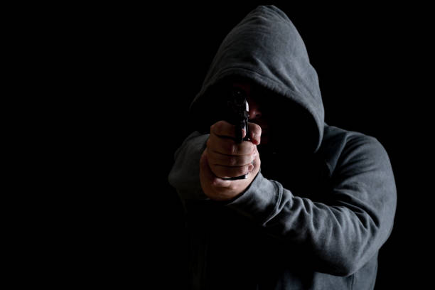 istock Thug in hoodie points gun 638537484