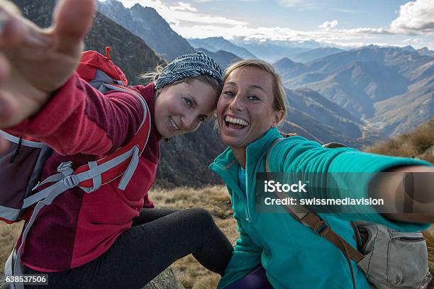 Two Young Women Hiking Take Selfie Portrait At Mountain Top Stock Photo - Download Image Now