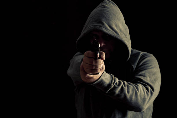 istock Thug in hoodie points gun 638537558