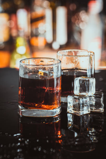 istock two glasses of whiskey on a blurred background bar 638537600