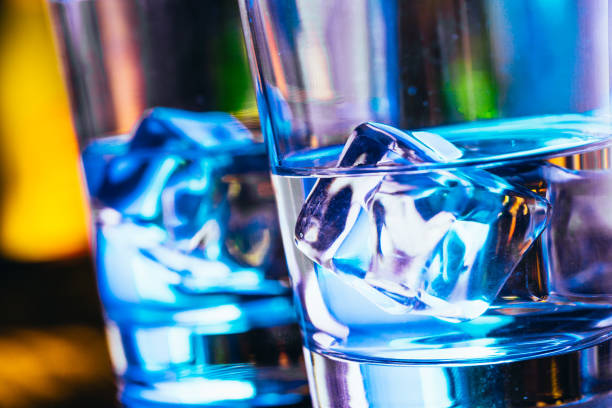 Two glasses of vodka with ice closeup.