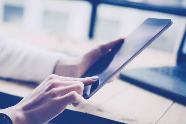 istock Closeup view of female hand touching screen digital tablet at 638543628
