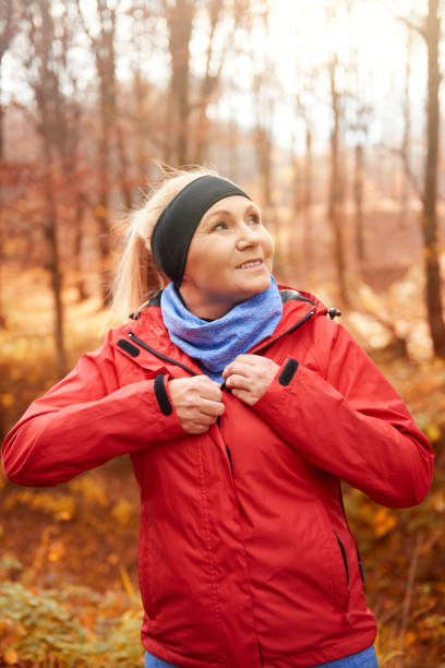 istock Older woman runner is zipping her jacket 638544030