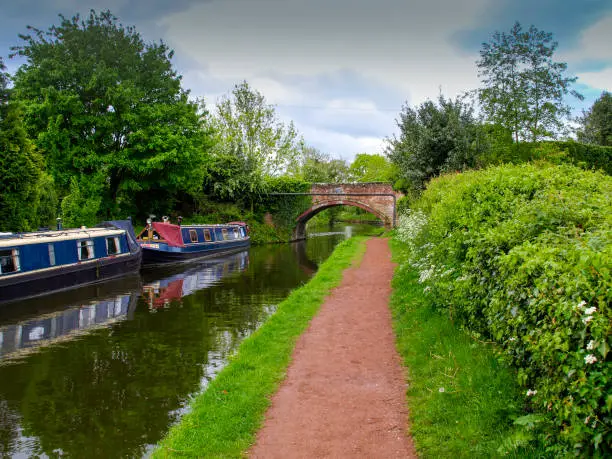 Bridge with towpath and mooring narrowboats in Penkridge on the Staffordshire and Worcestershire canal