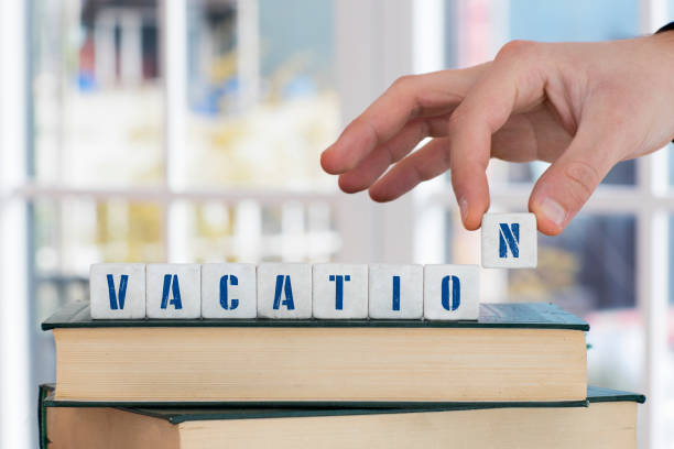 istock VACATION Concept , Hand with alphabet blocks 638545046