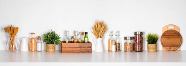 Kitchen shelf with various herbs, spices, utensils on white background