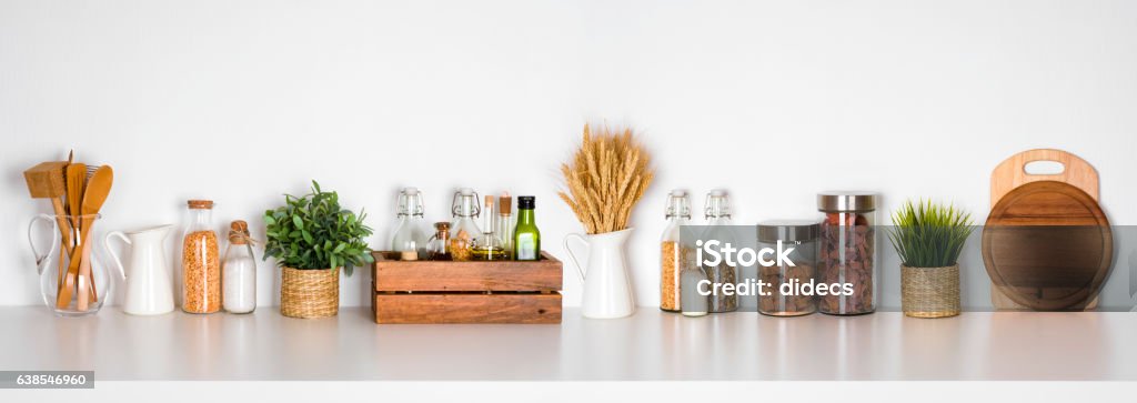 Kitchen shelf with various herbs, spices, utensils on white background Kitchen Utensil Stock Photo