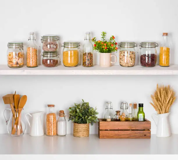 Photo of Modern kitchen shelves with various food ingredients on white background