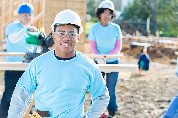 istock Confident male construction foreman oversees crew 638549662