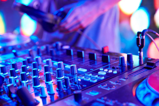 DJ playing the turntable DJ playing and controling the track in the nightclub at a colorful party dance  electronic music photos stock pictures, royalty-free photos & images