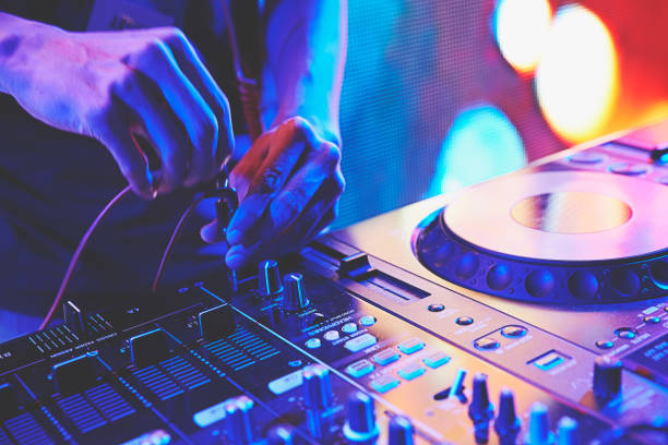 DJ playing the turntable DJ playing and controling the track in the nightclub at a colorful party dance  electronic music photos stock pictures, royalty-free photos & images