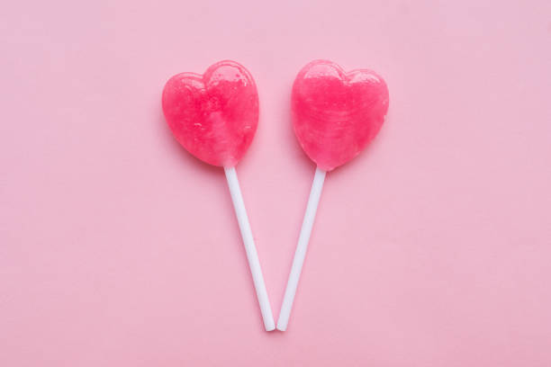 istock Pink Valentine's heart shape lollipop candy empty pastel pink background 638551600