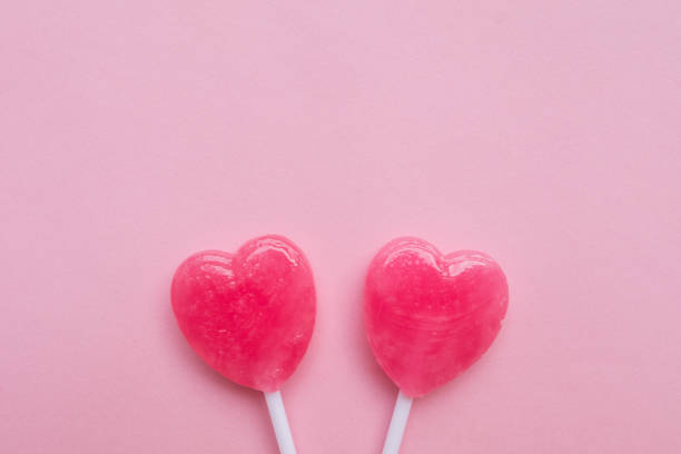 istock Pink Valentine's heart shape lollipop candy empty pastel pink background 638551654