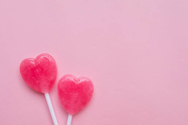 istock Pink Valentine's heart shape lollipop candy empty pastel pink background 638551734