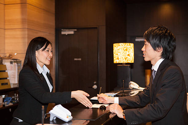 Businessman check-in Hotel Reception in Tokyo stock photo