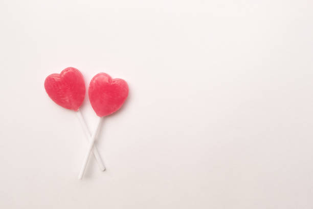 istock Pink Valentine's heart shape lollipop candy empty pastel white background 638552194