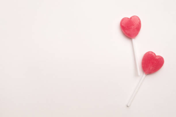 istock Pink Valentine's heart shape lollipop candy empty pastel white background 638552236