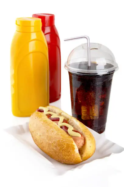 Photo of Hotdog with mustard, ketchup in tray with cola on white