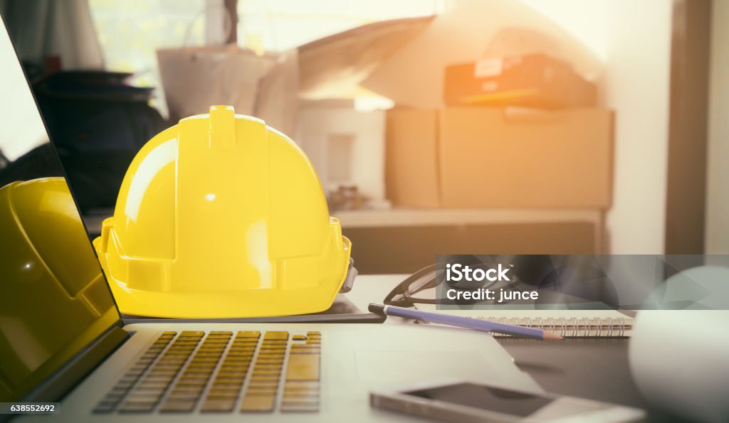 Construction worker office desk with laptop computer. Occupational Safety And Health Stock Photo