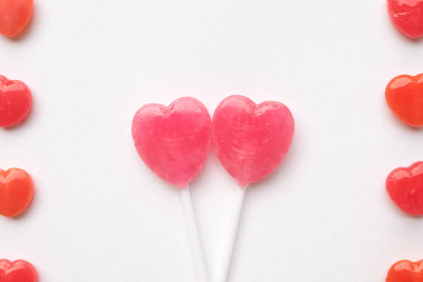 istock Pink Valentine's heart shape lollipop candy pastel white background 638552940