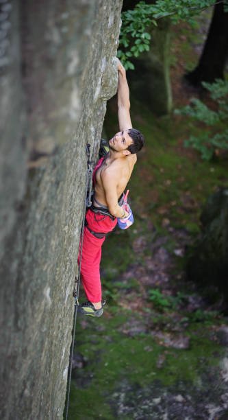 istock Muscular rock climber climbs on overhanging cliff 638553134