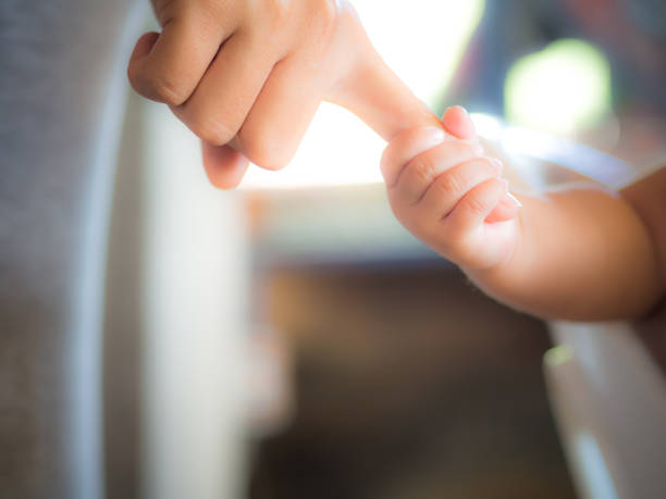 istock Baby finger grip, his mother. 638555916