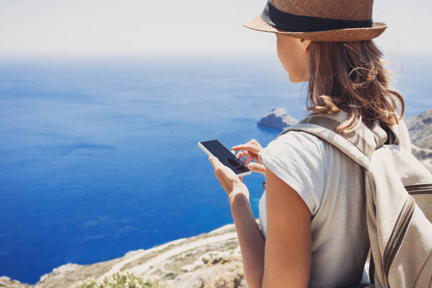 istock Young woman using smart phone on vacations 638557428