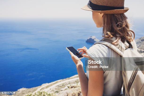 Young Woman Using Smart Phone On Vacations Stock Photo - Download Image Now - Mobile Phone, Vacations, Smart Phone