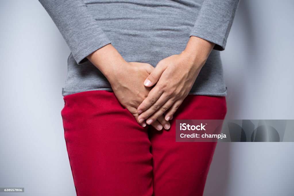 Woman with hands holding her crotch Dependency Stock Photo