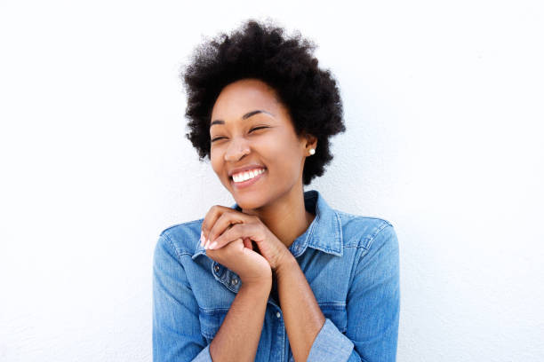 istock Delighted woman smiling by white wall 638559542