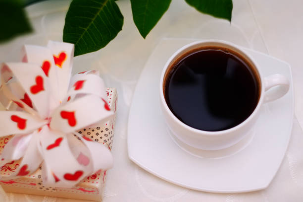 istock cup of hot coffee and a gift 638559658